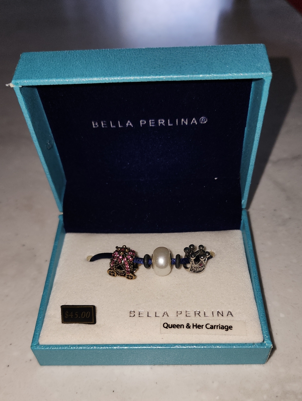 Bella Perlina pink-accent carriage, white pearl, &Queens Crown Charms